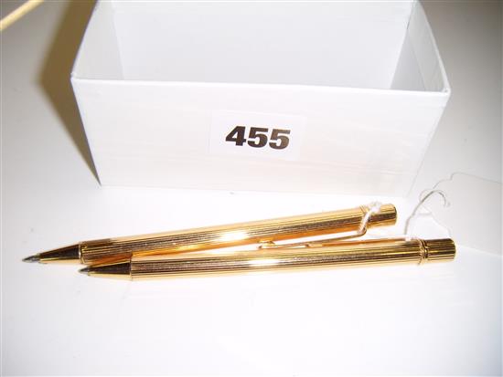 Two Cartier gilt ballpoint pens